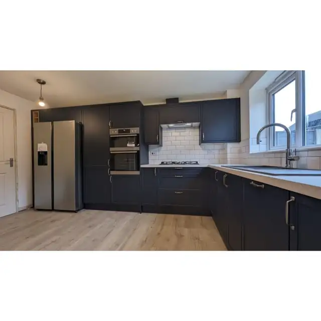 Navy shaker kitchen with white metro tile splashback